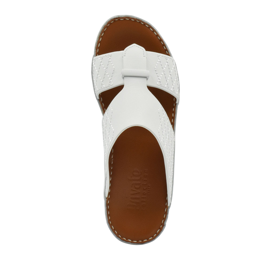White designer leather sandals with brown footbed and stitched detailing from Private collection