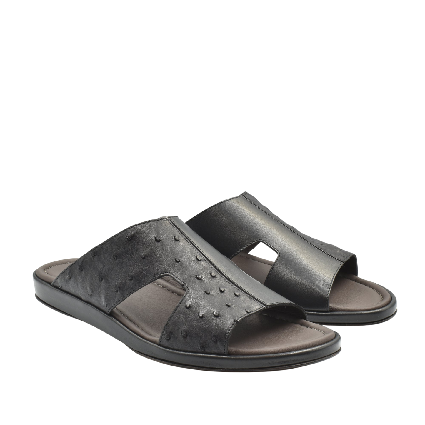 Black ostrich skin slide sandals with open toe design and cushioned footbed