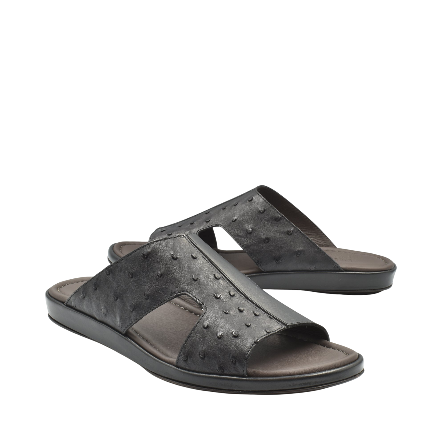 Black ostrich skin slide sandals with textured leather upper and comfortable cushioned sole