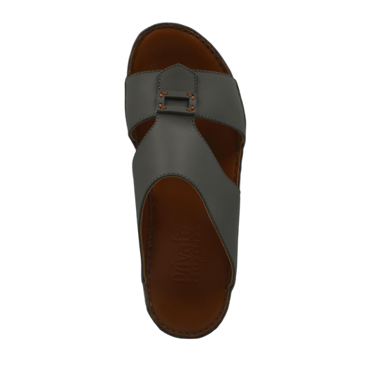 Top view of gray Italian leather sandals with buckle detail and brown insole from private collection