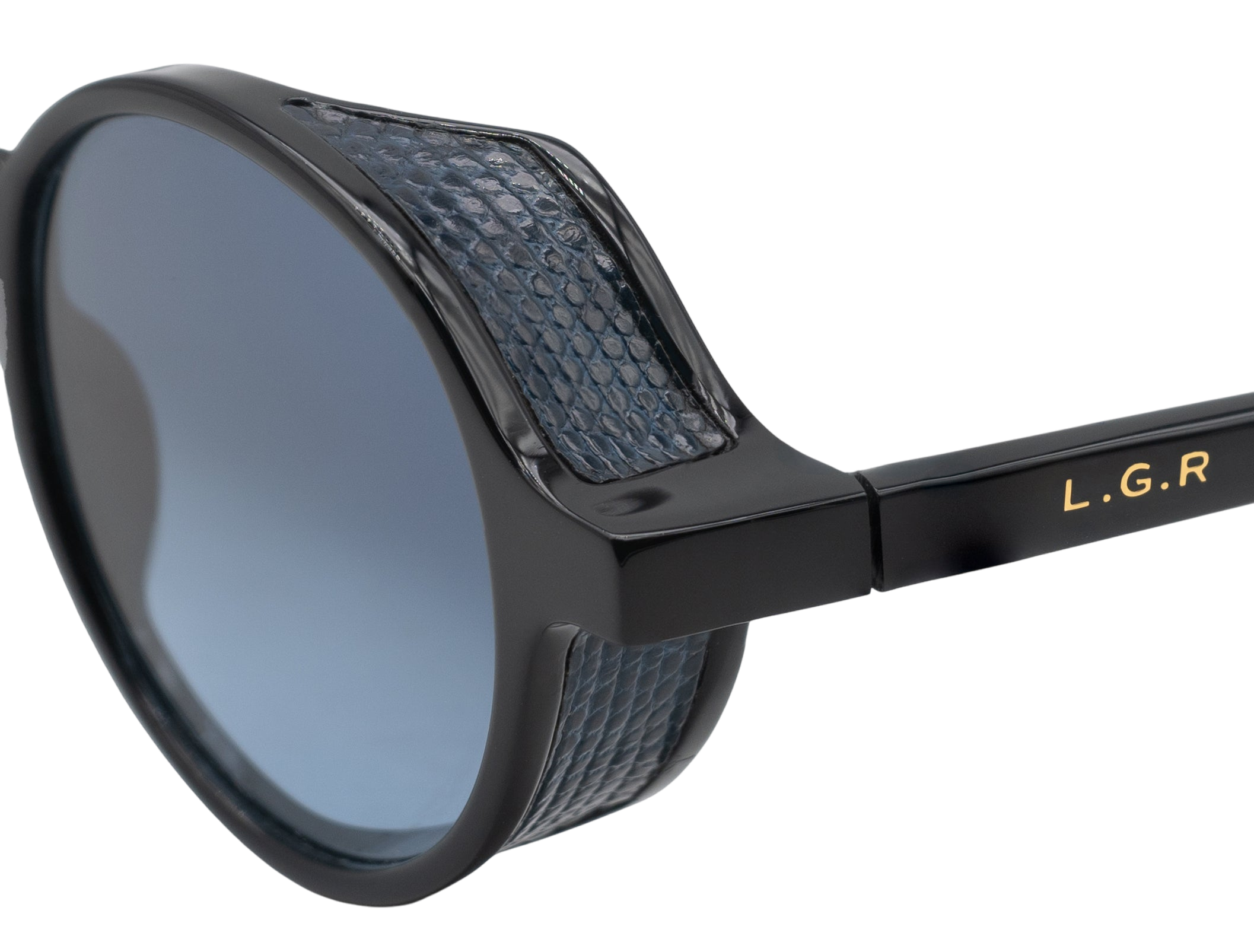 Close-up of black sunglasses with blue textured detailing from a luxury eyewear collection