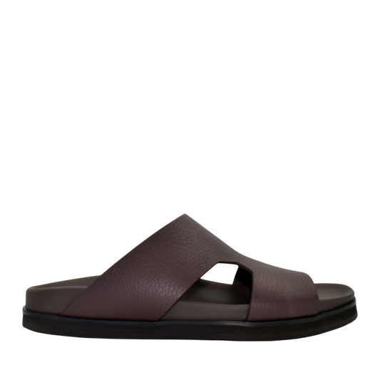 Side view of brown luxury leather sandals with wide straps and cushioned sole