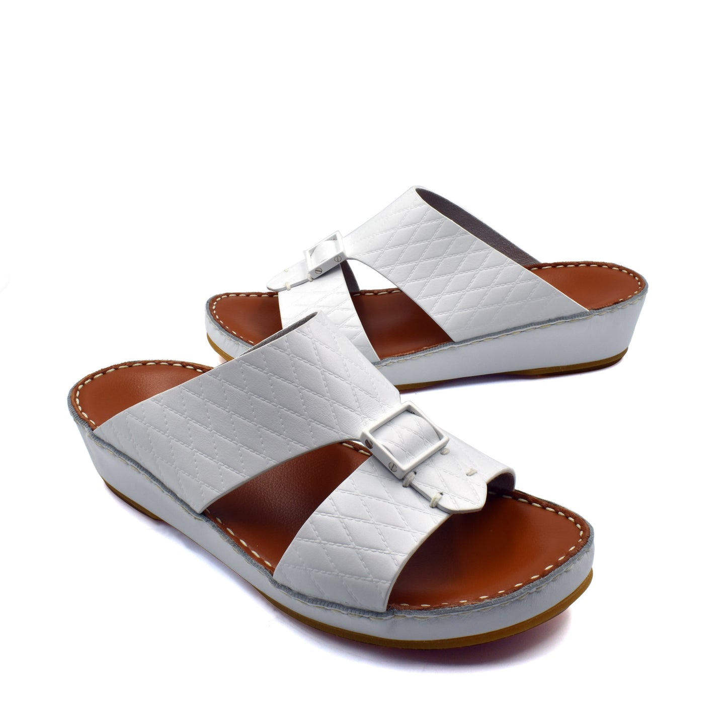 White luxury leather sandals with quilted straps and buckle detail on brown cushioned sole