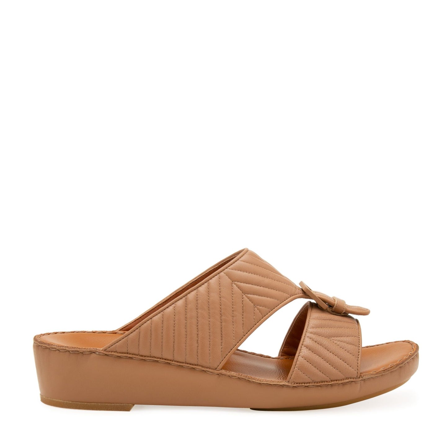 Tan wedge slide sandals featuring luxury matelasse footwear design with quilted straps and buckle detail