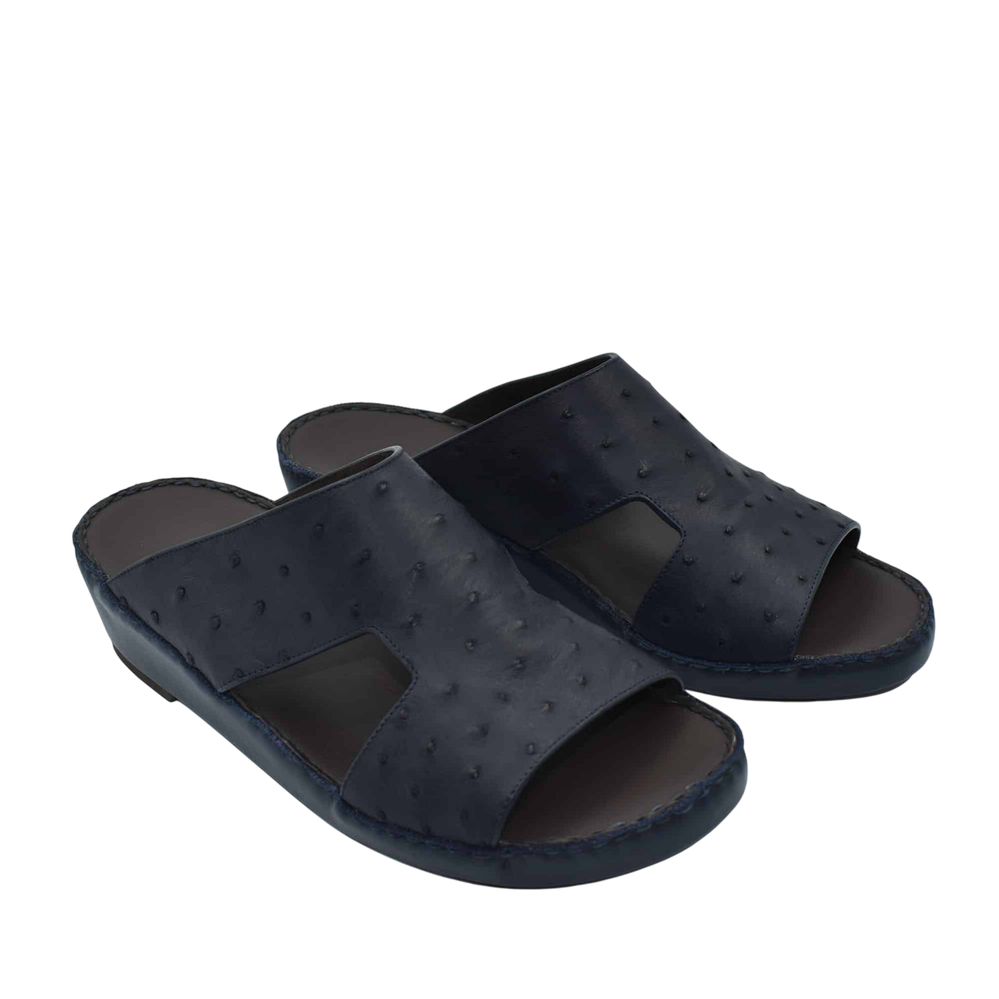 Pair of black luxury ostrich sandals with open toe design and textured leather upper