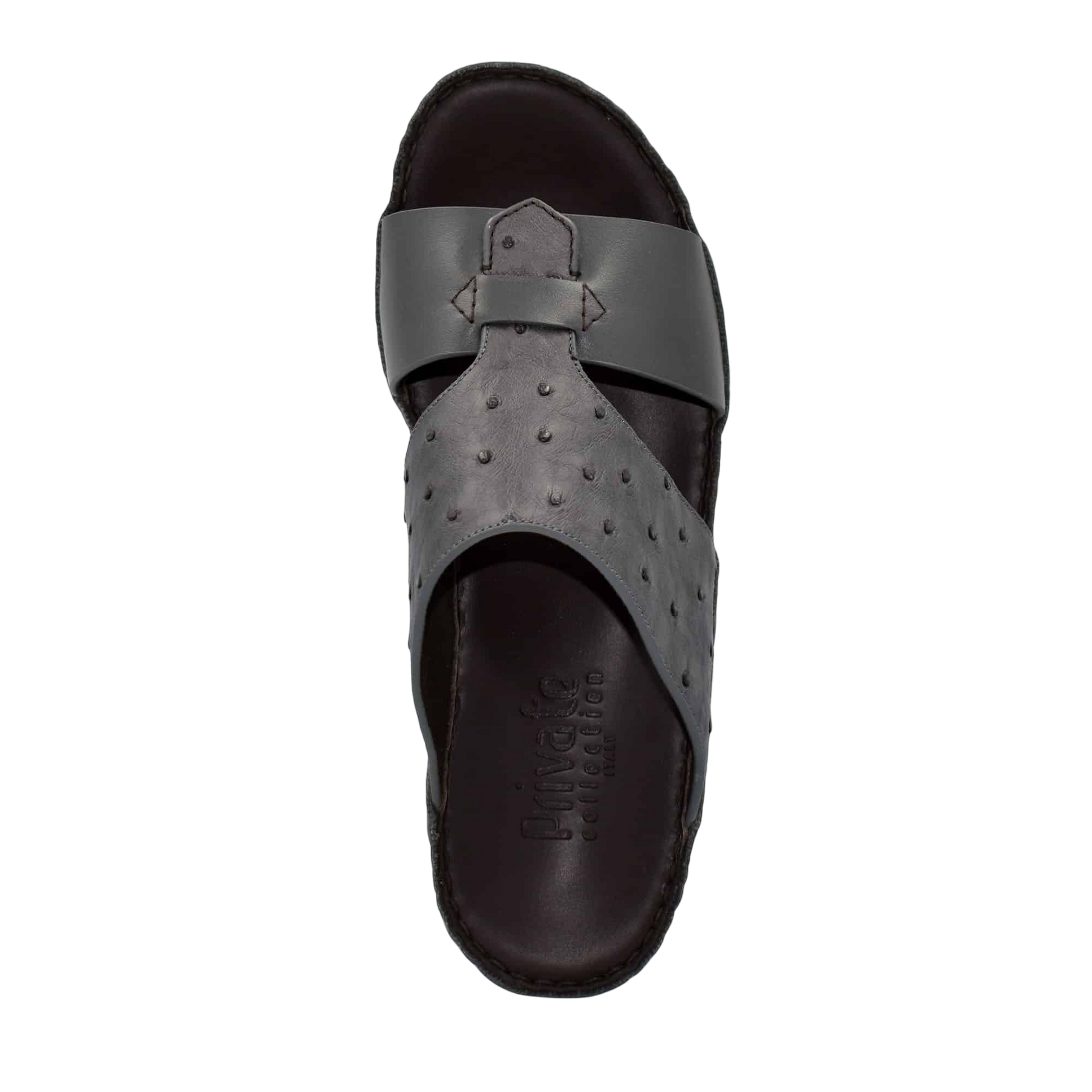 Black ostrich embossed slip on sandals with textured upper and cushioned sole for comfort