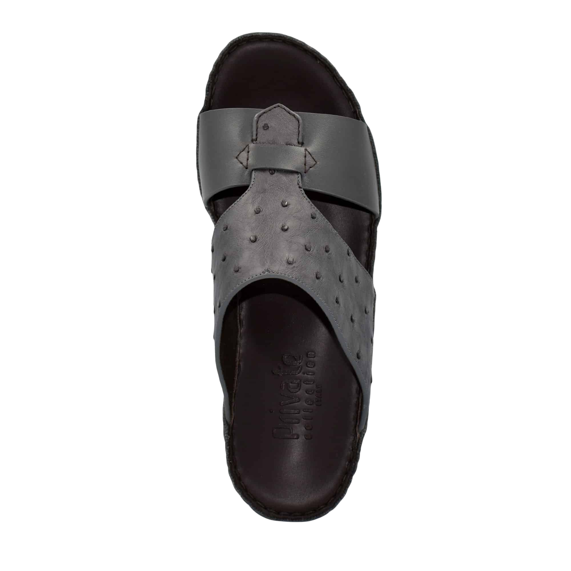 Black ostrich embossed slip on sandals with textured upper and cushioned sole for comfort