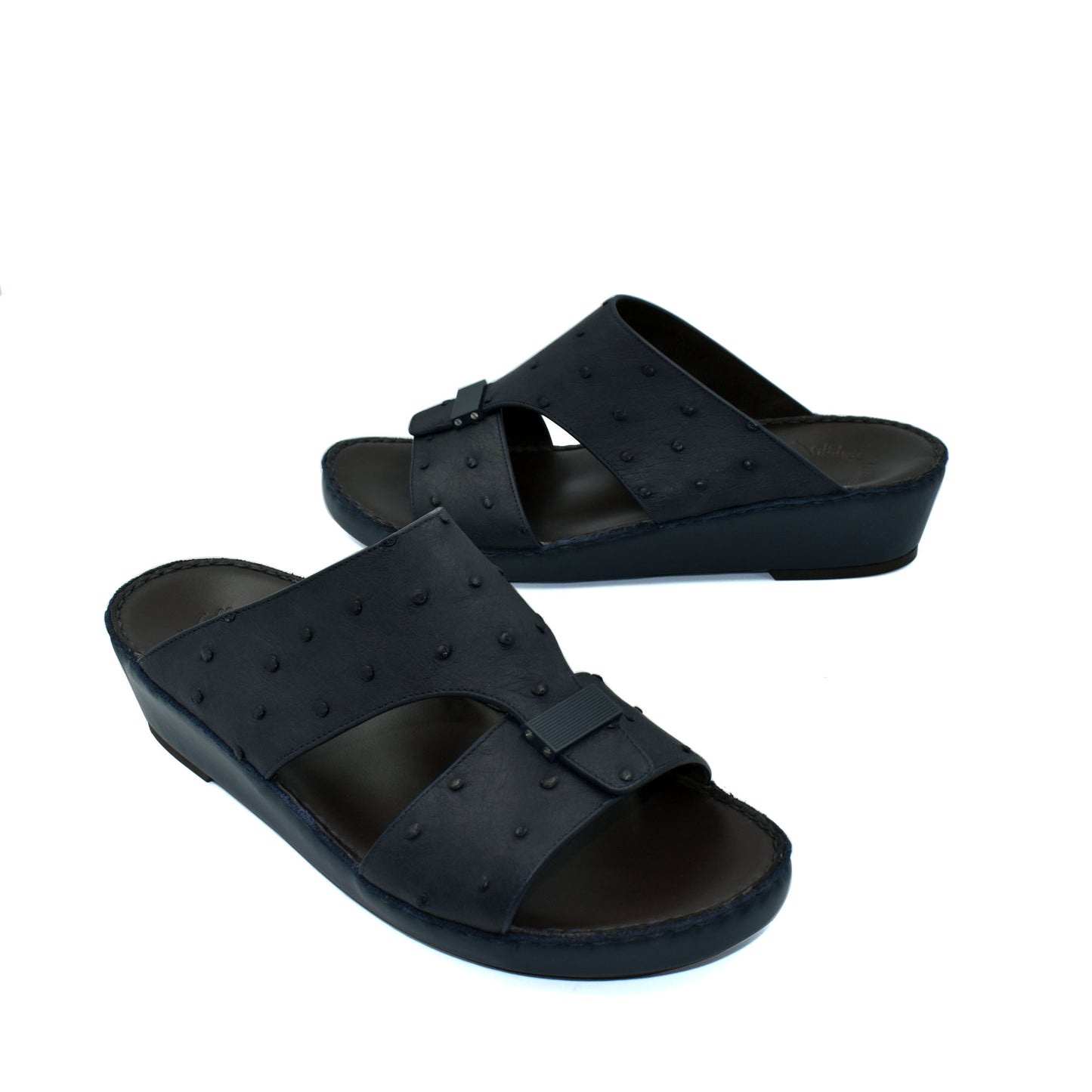 Black ostrich leather sandals with buckle detail and comfortable wedge sole