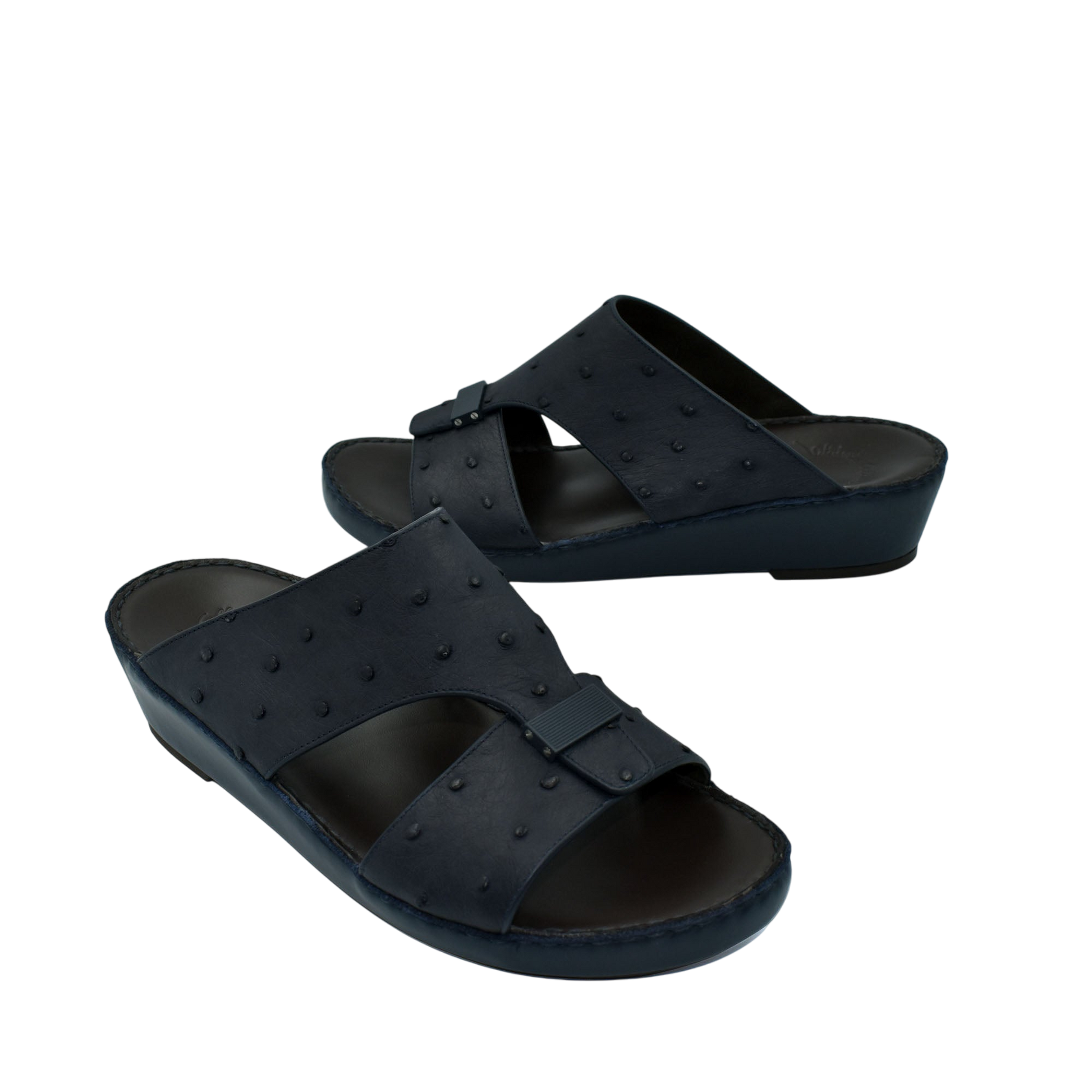 Black ostrich leather sandals with buckle detail and comfortable wedge sole