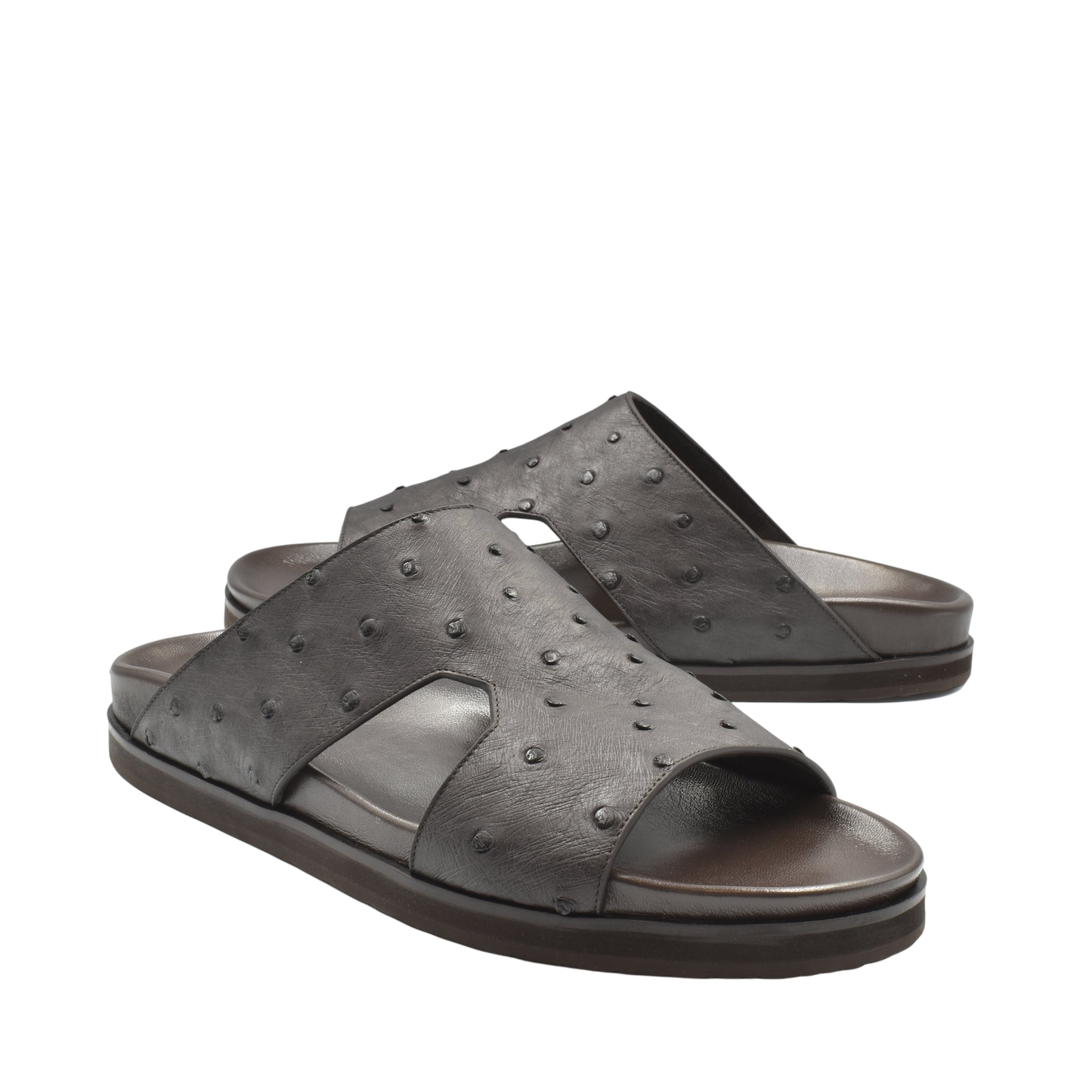 Pair of premium ostrich leather footwear black slide sandals with textured surface and open toe design