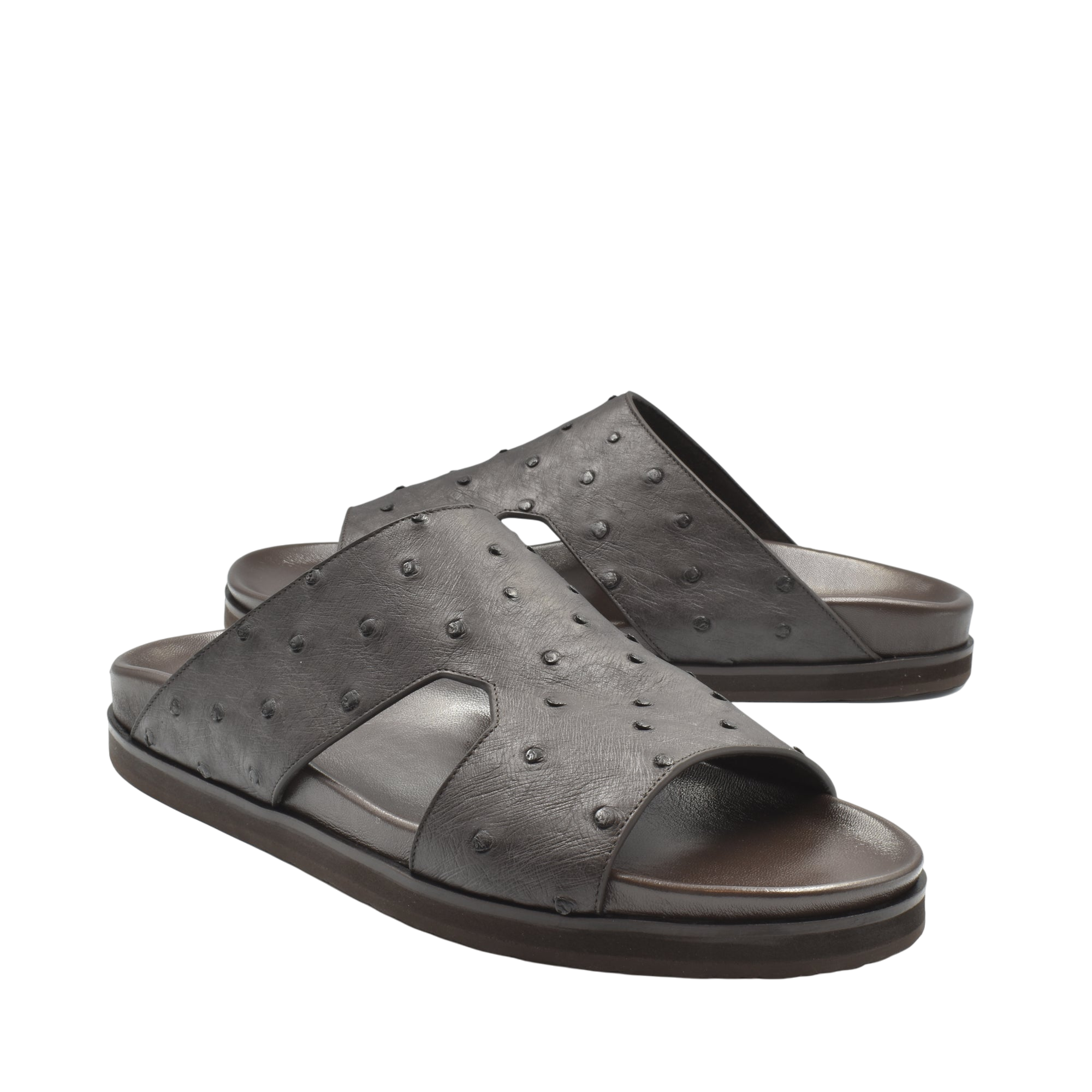 Pair of premium ostrich leather footwear black slide sandals with textured surface and open toe design