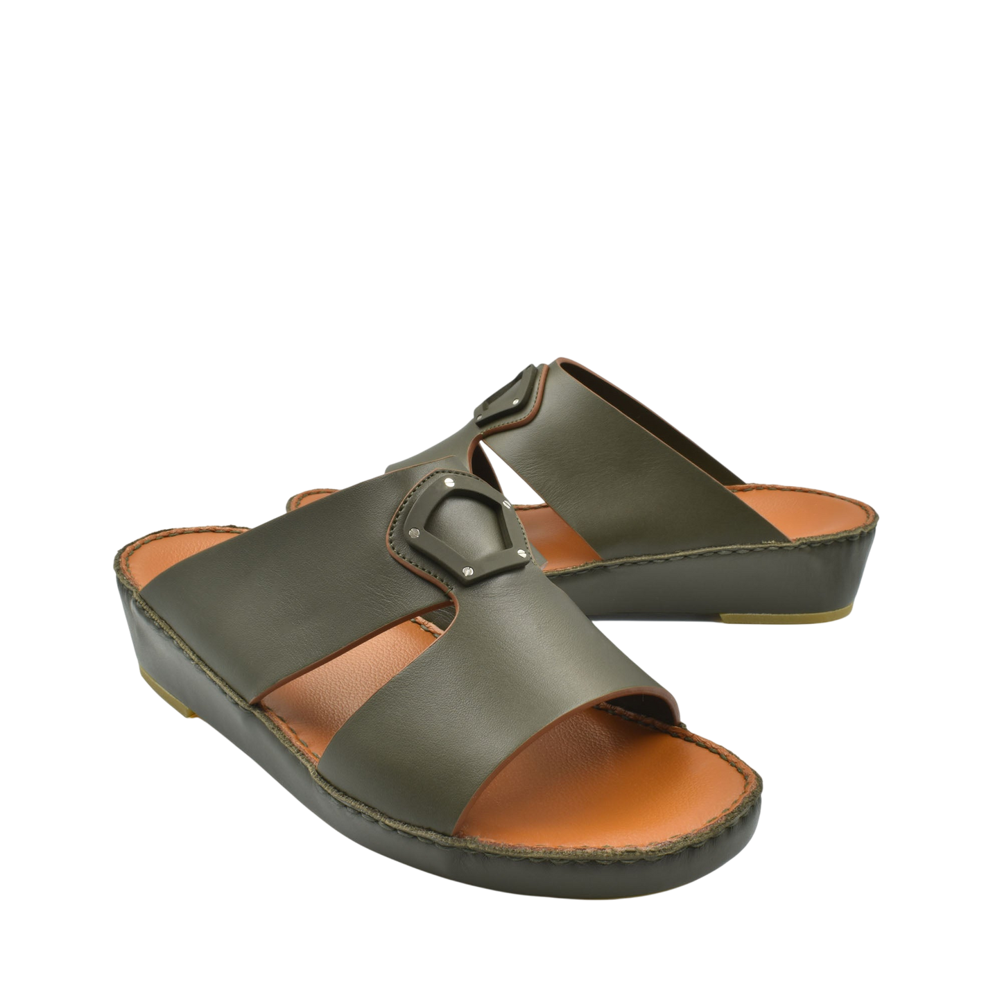 Pair of green natural leather slide shoes with buckle detail and cushioned sole for comfort