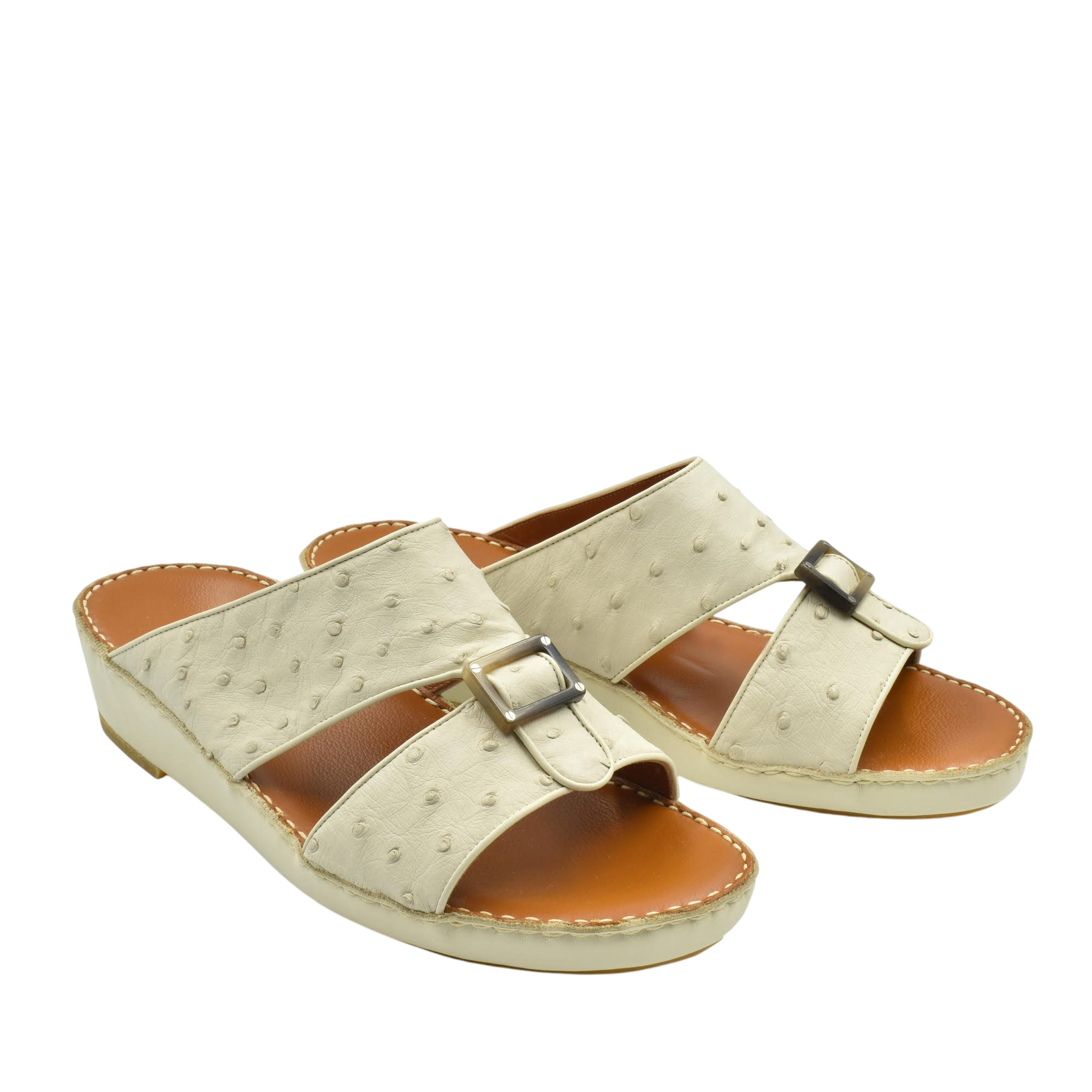 Beige ostrich leather sandals with buckle detail and cushioned tan footbed for comfort