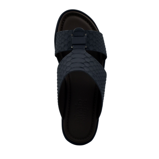 Top view of black python skin footwear slip-on sandal with textured straps and cushioned sole