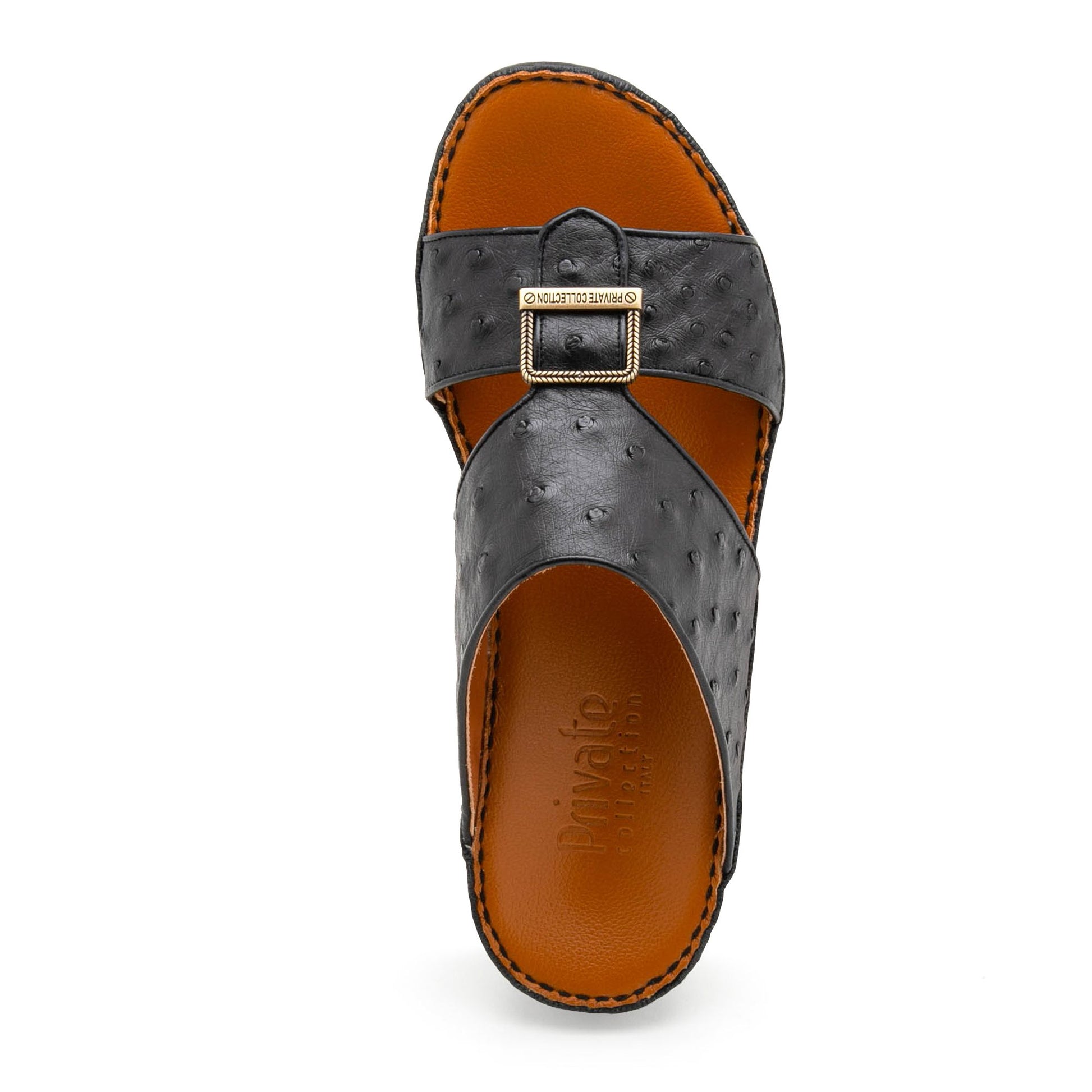 Black luxury leather sandals with textured straps and gold buckle from Private collection