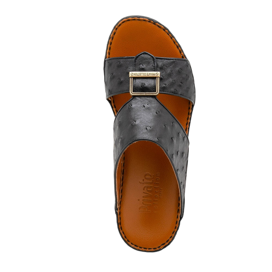 Black luxury leather sandals with textured straps and gold buckle from Private collection