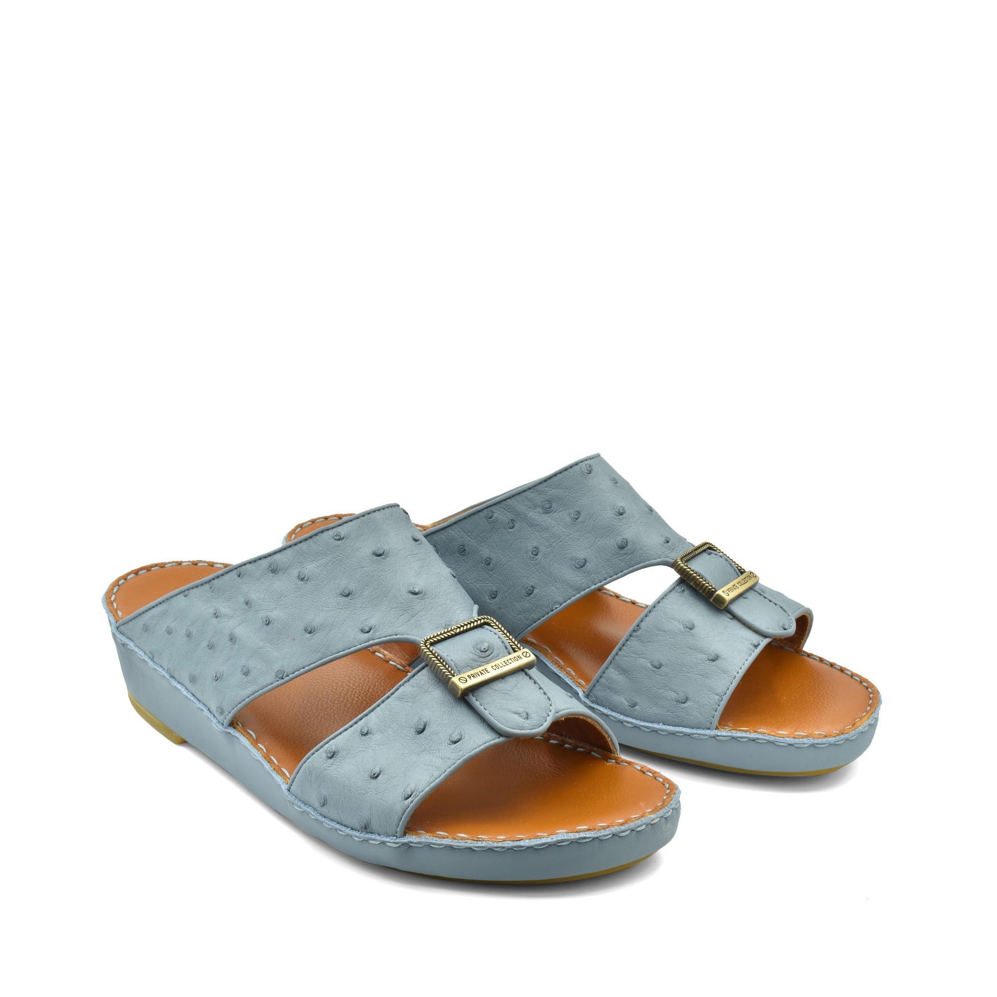 Gray luxury leather sandals with buckle detail and cushioned tan footbed from Private collection