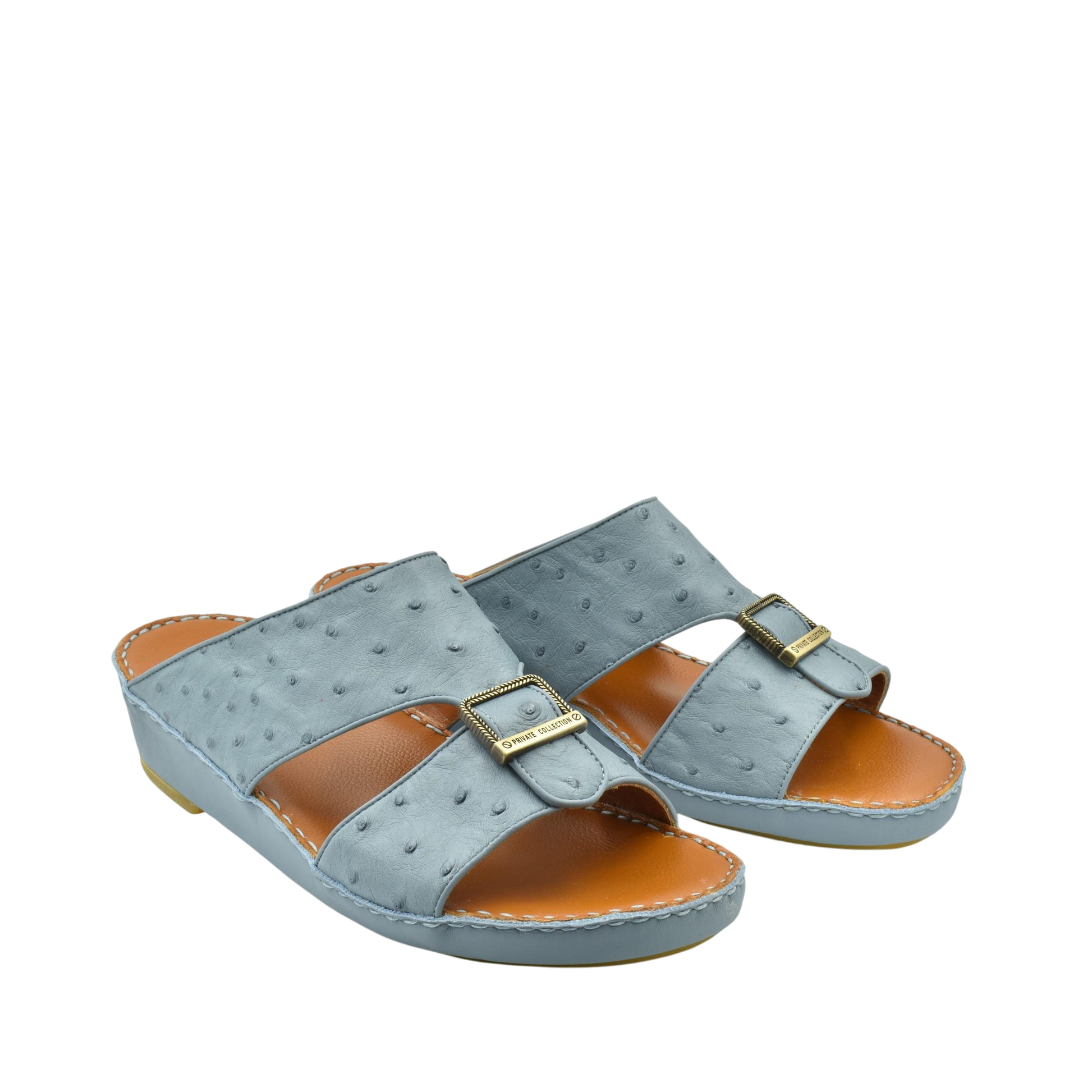 Gray luxury leather sandals with buckle detail and cushioned tan footbed from Private collection