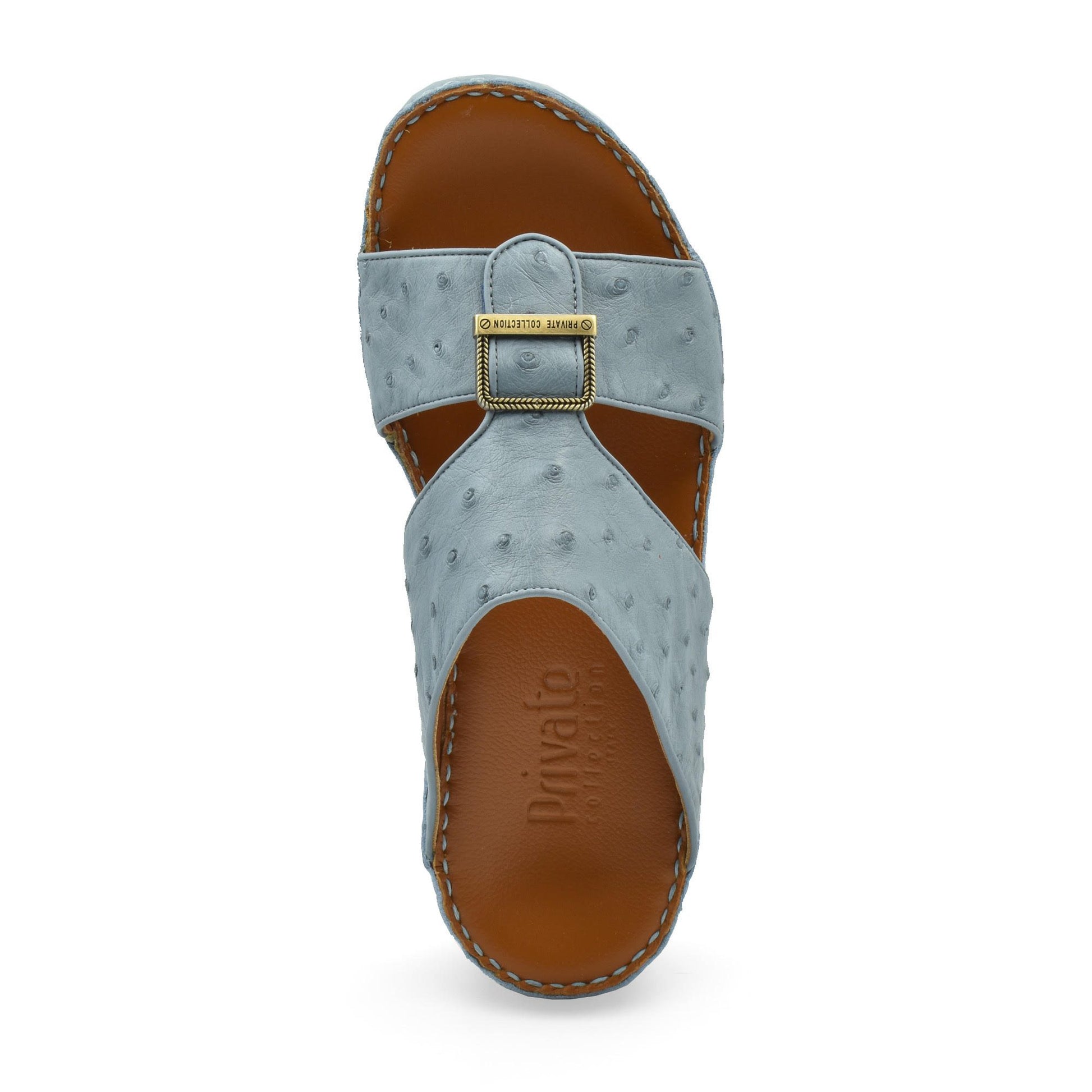 Top view of luxury leather sandals in light blue with stitched brown sole and gold buckle detail