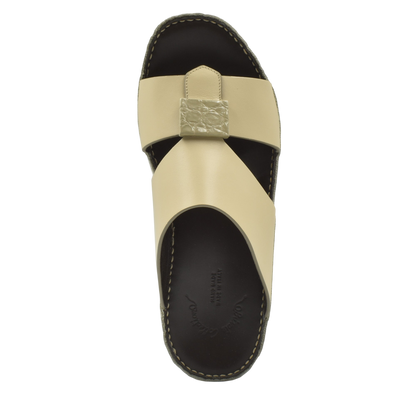 Beige Cerchio buckle sandals with black sole and textured buckle detail from Private Collection