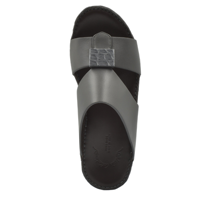 Top view of gray Cerchio buckle sandals with crisscross leather straps and textured buckle detail