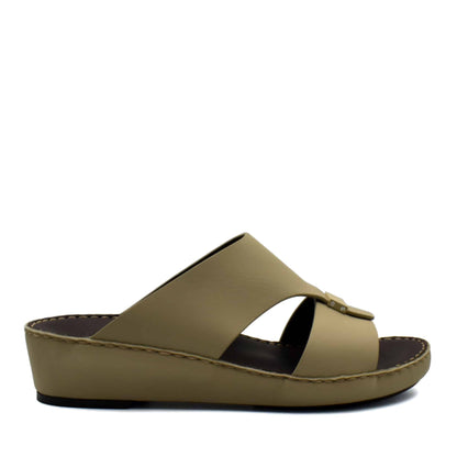 Side view of beige Cerchio Gomato sandals with a wedge sole and crossed straps