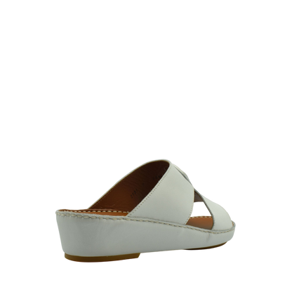 White comfortable leather slip-on sandals with a low wedge heel and cushioned insole
