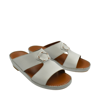 Comfortable leather slip-on sandals in light gray with cushioned brown insoles and decorative buckle detail
