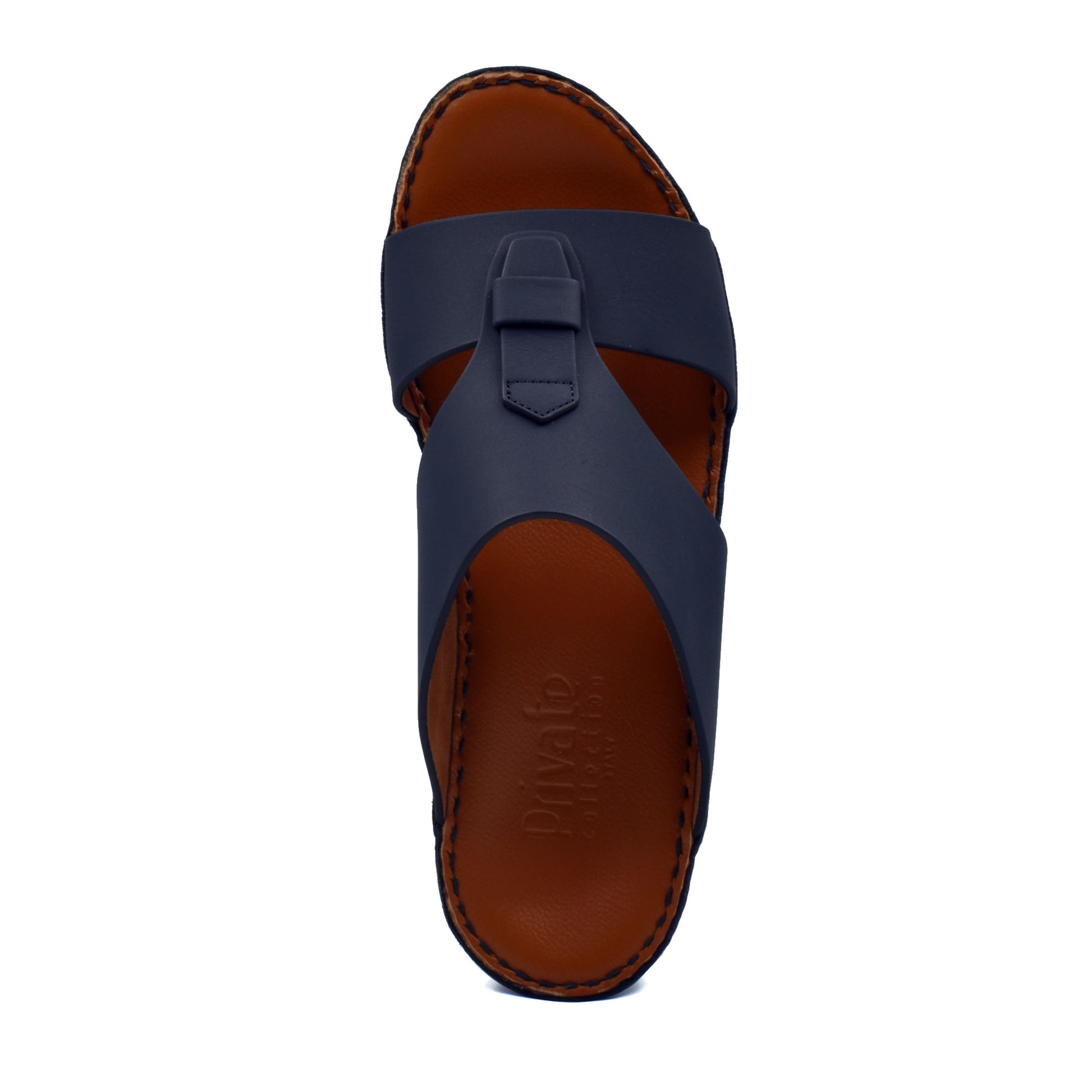 Top view of comfortable rubber slides in navy blue with brown cushioned sole from Private Collection
