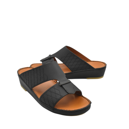Black designer leather sandals with quilted straps and cushioned tan footbed for comfort