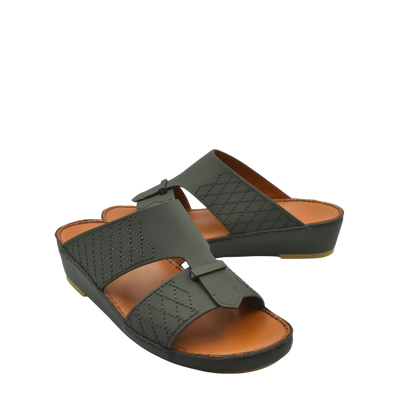 Black designer leather sandals with cushioned brown footbed and stitched detailing