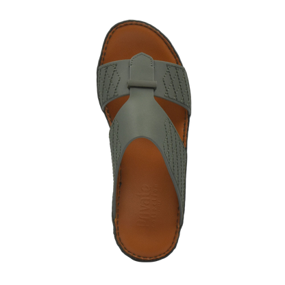 Top view of gray designer leather sandals with brown cushioned sole from Private Collection