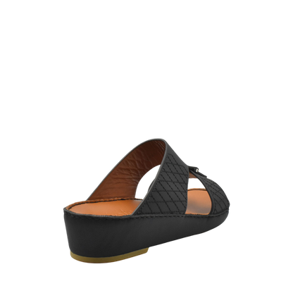 Black designer leather sandals with quilted straps and cushioned brown insole from private collection