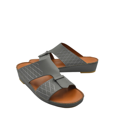 Gray designer leather sandals with stitched detailing and cushioned brown footbed for comfort