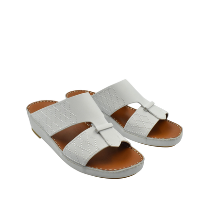 White designer leather sandals with quilted stitching and open toe slip-on style