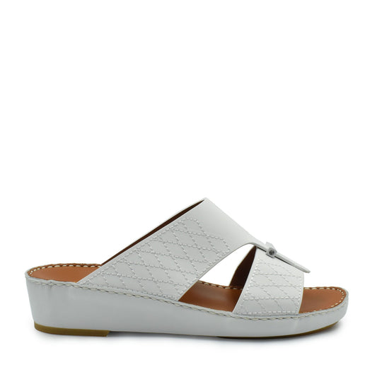 White designer leather sandals with quilted pattern and low wedge sole from Private collection
