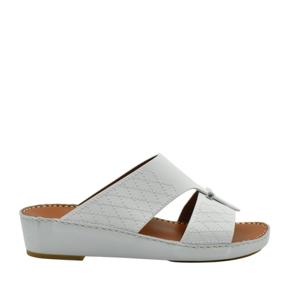White designer leather sandals with quilted pattern and low wedge sole from Private collection