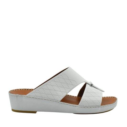 White designer leather sandals with quilted pattern and low wedge sole from Private collection