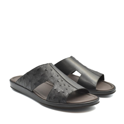 Black ostrich skin slide sandals with open toe design and cushioned footbed
