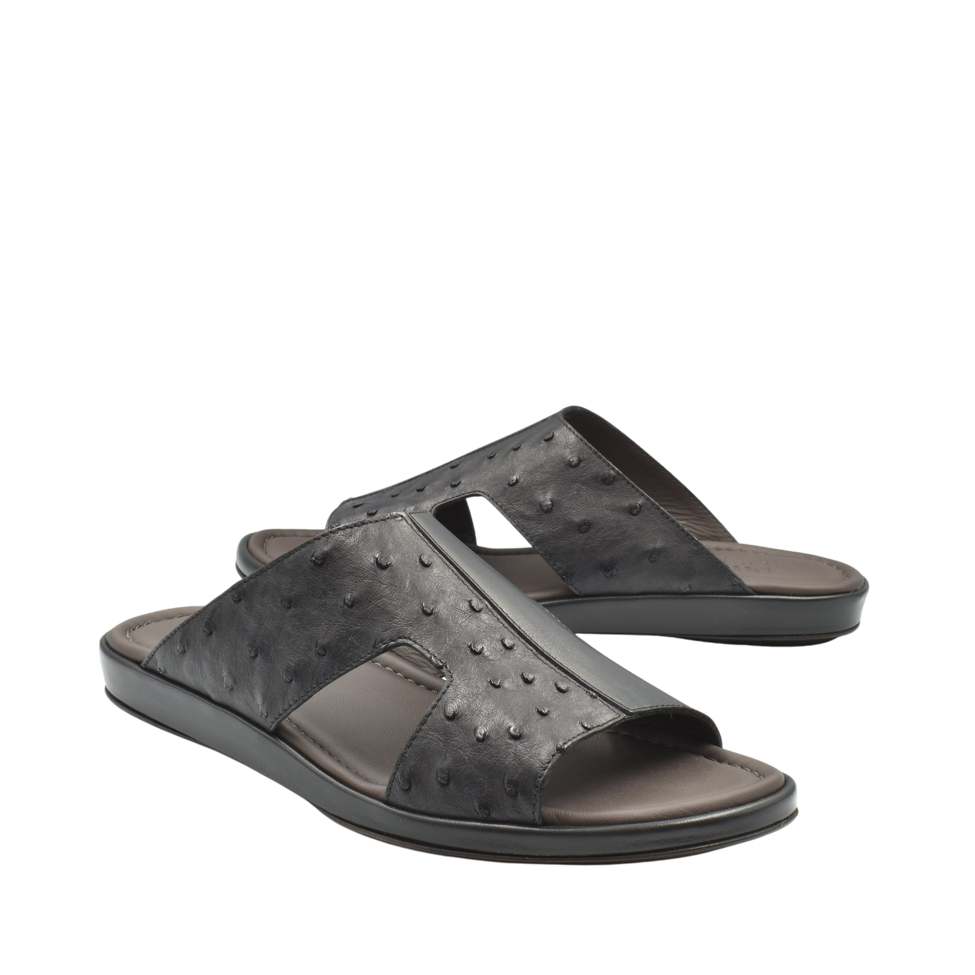 Black ostrich skin slide sandals with textured leather upper and comfortable cushioned sole