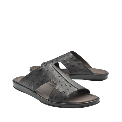 Black ostrich skin slide sandals with textured leather upper and comfortable cushioned sole