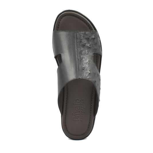 Black ostrich skin slide sandals from Private Collection with textured upper and open toe design