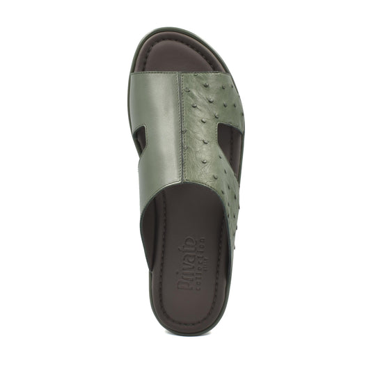 Olive green ostrich skin slide sandals with textured leather upper and cushioned footbed