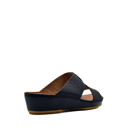 Black slip-on handcrafted Italian sandals with quilted leather straps and low wedge heel