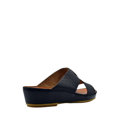 Black slip-on handcrafted Italian sandals with quilted leather straps and low wedge heel