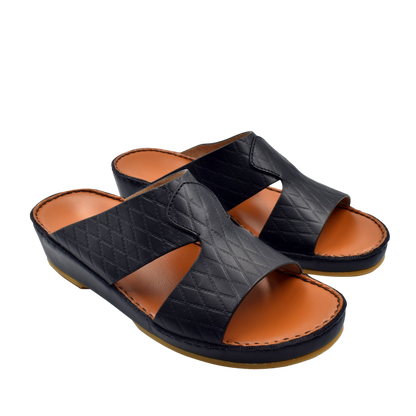Black handcrafted Italian sandals with quilted leather straps and tan cushioned footbed by Private Collection