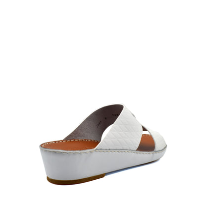 White handcrafted Italian sandals with quilted straps and low wedge heel from Private Collection