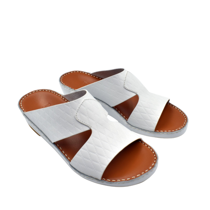 White handcrafted Italian sandals with brown footbed and stitched detailing from Private Collection