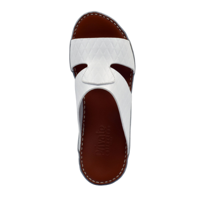 White handcrafted Italian sandals with quilted leather straps and brown footbed by Private Collection