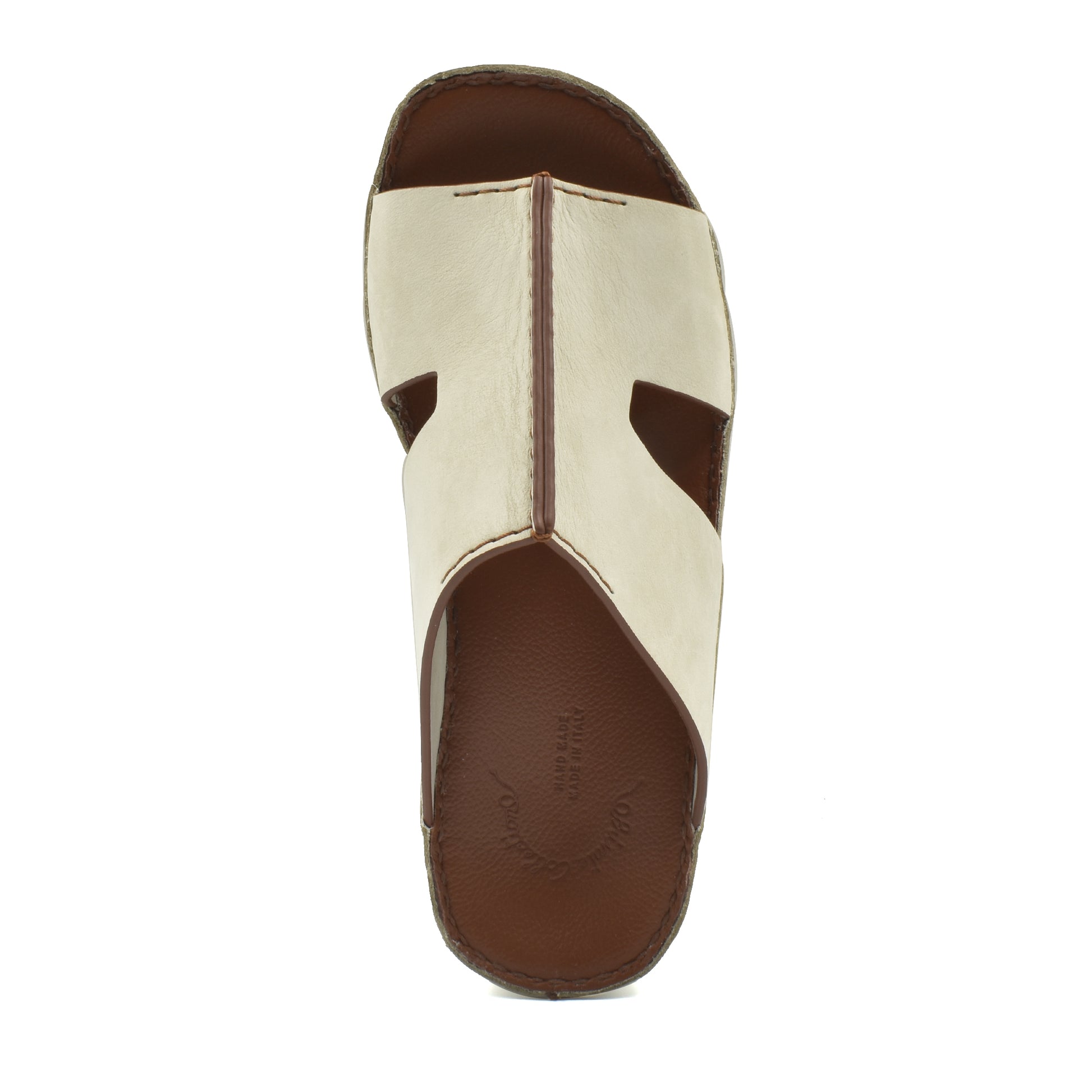 Top view of handcrafted leather shoes in white and brown with open toe design